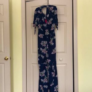 Adorable Navy Xhiliration Jumpsuit with Pockets! Bow at neck and arms. NWT XXL